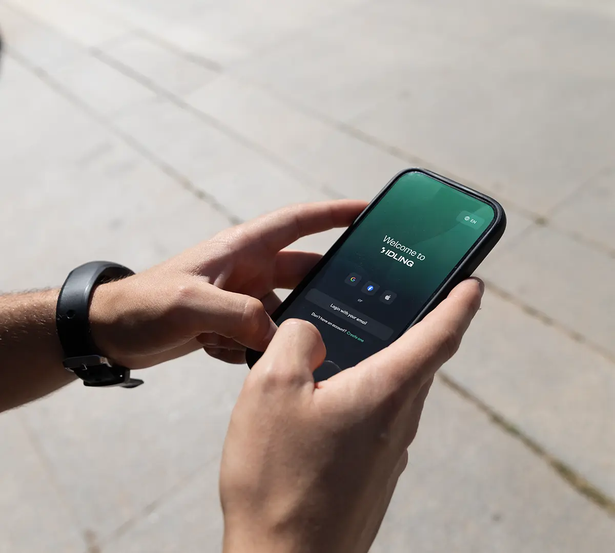 Hands holding a smartphone on a brushed metal surface